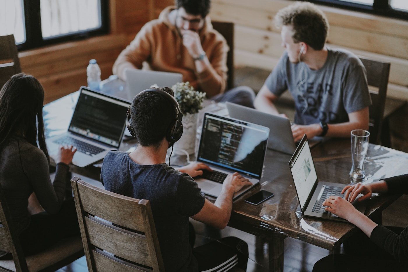 Coworkers working at laptops around a shared table