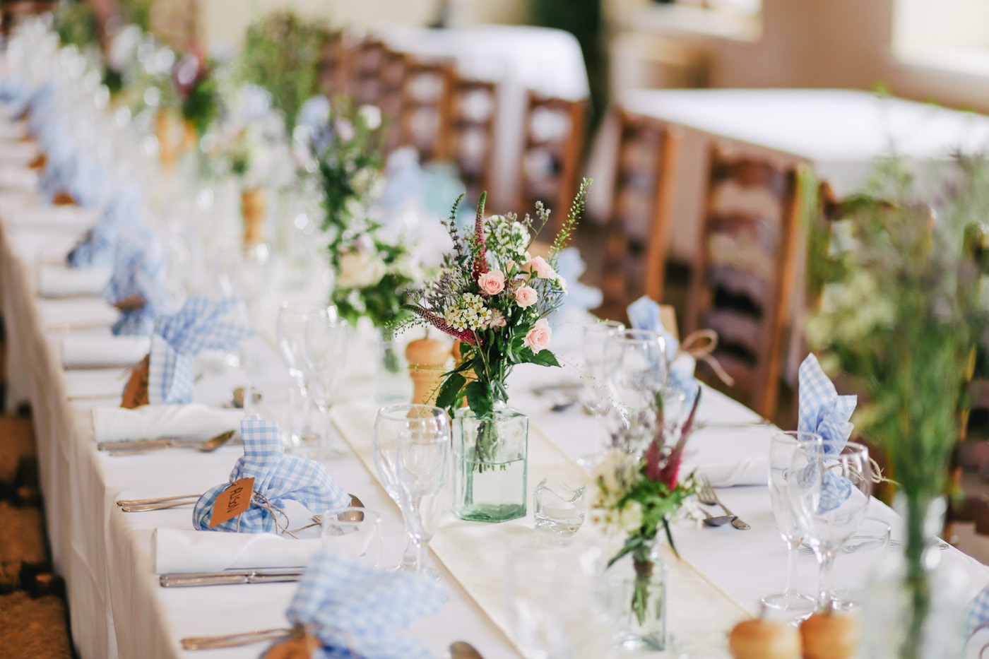 A long wedding table dressed with white flowers