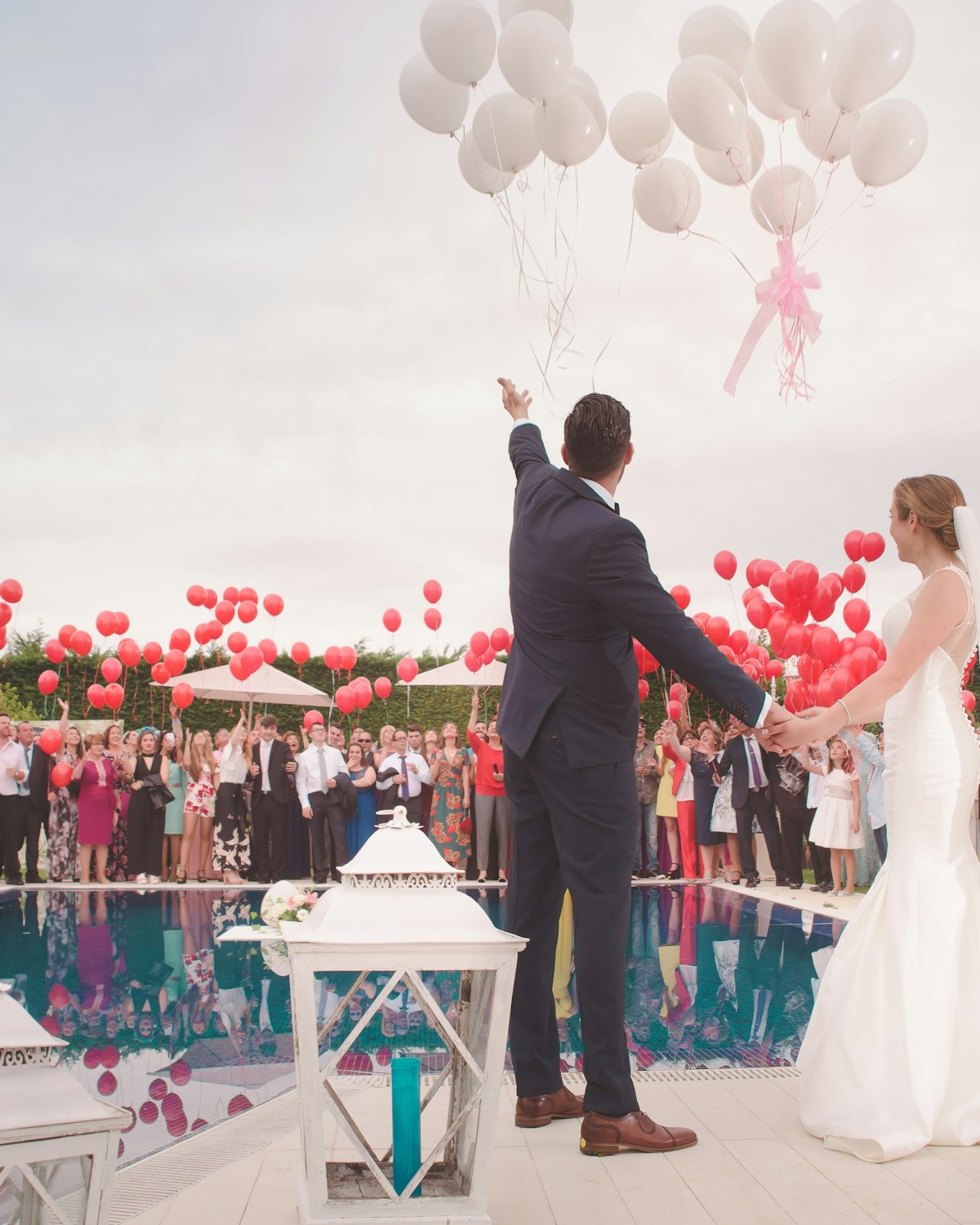 A newly married couple celebrating beside a pool